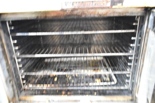 Bakers Pride Cyclone convection oven, stainless steel, metal racks, thermostatic controls, metal legs, worn condition.