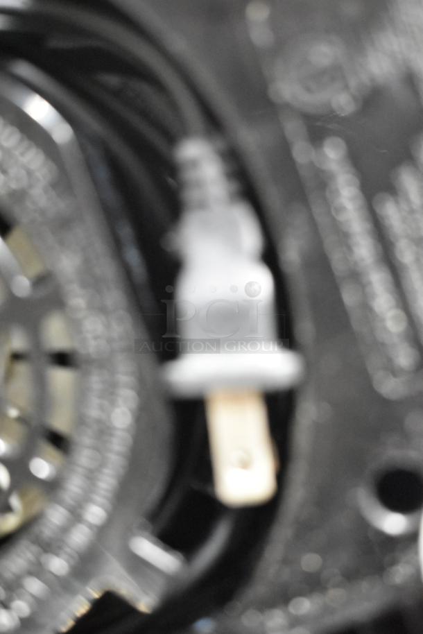 Blurred image of a Spectrum FP4200 countertop food processor plug. Item details include 120 Volts, 1 Phase.