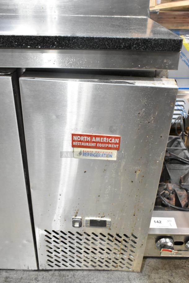 2019 Atosa P-93-GR stainless steel pizza prep table with black stone cutting board, commercial casters, and visible wear marks.