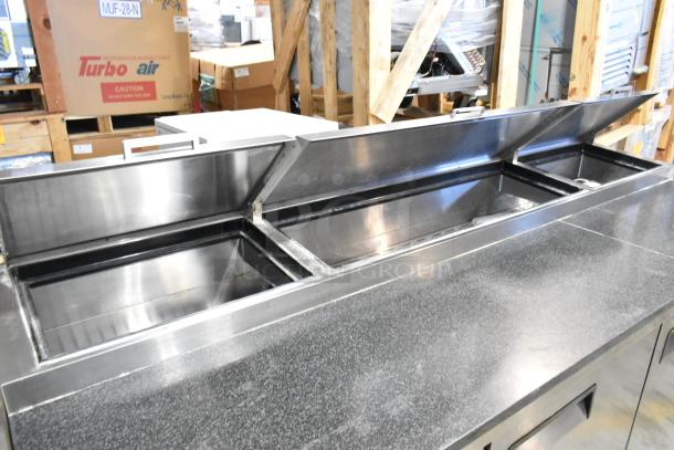 2019 Atosa P-93-GR stainless steel pizza prep table with black stone pattern cutting board. Commercial casters, 115V, 1 phase.