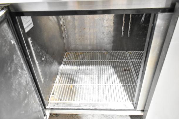2019 Atosa P-93-GR stainless steel pizza prep table interior, features wire shelving, commercial-grade, on casters.
