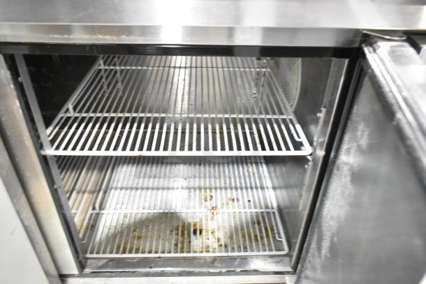 2019 Atosa P-93-GR stainless steel pizza prep table interior with wire shelves, showing slight wear.