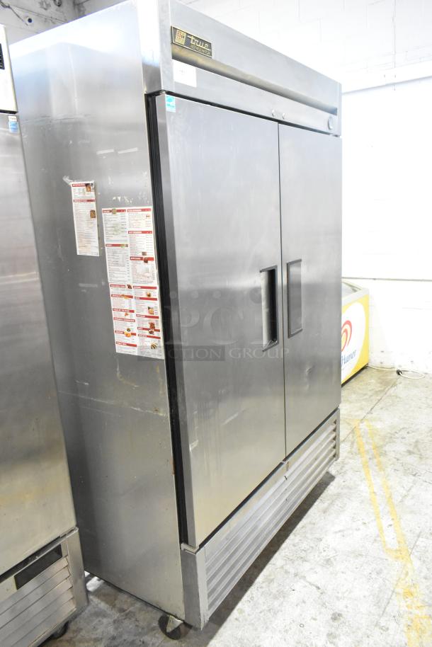 2016 True T-49 stainless steel commercial 2-door reach-in cooler with poly-coated racks, on casters. 115V, 1 phase.