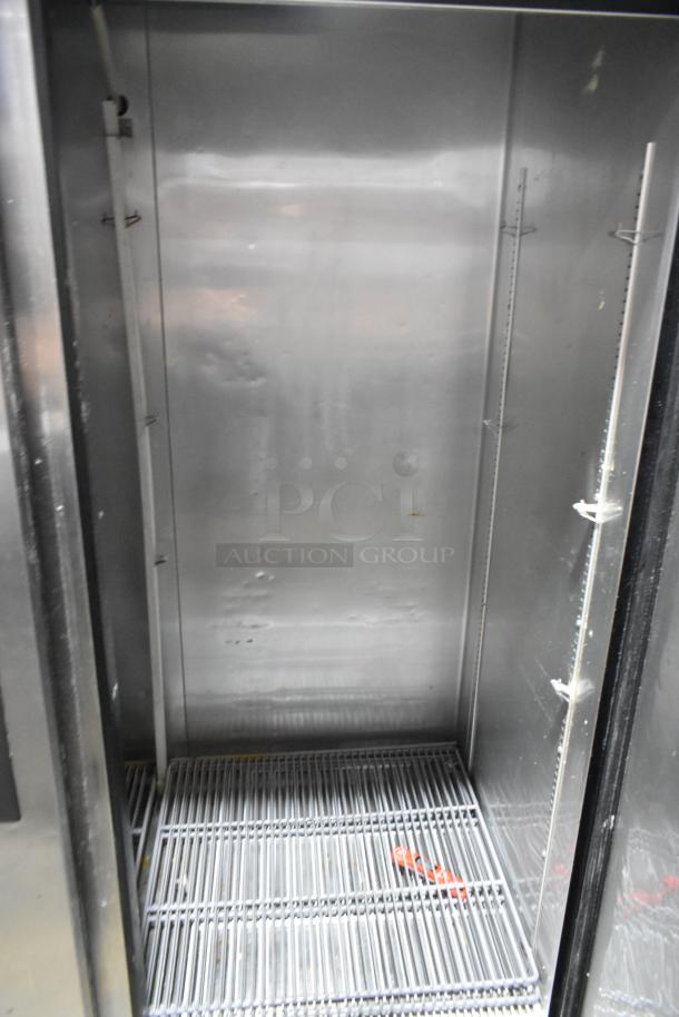 2016 True T-49 2 Door Stainless Steel Cooler, poly-coated racks, commercial casters, interior view, good condition.