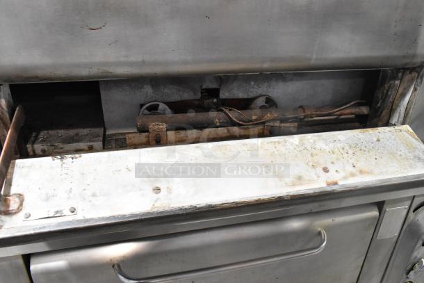 Blodgett 1000-S stainless steel commercial pizza oven, natural gas, single deck, with visible wear and pizza stones.