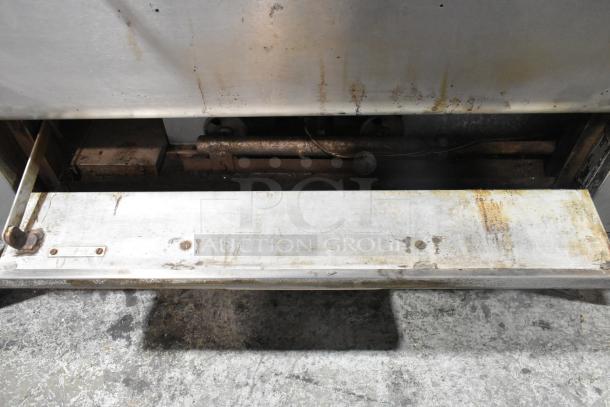 Blodgett 1000-S stainless steel natural gas pizza oven with visible wear, showcasing a compartment. 60,000 BTU, includes pizza stones.