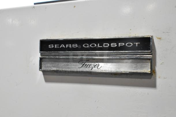 Sears Coldspot 106 single door metal freezer, 115 volts, 1 phase. Features prominent brand label and "Freezer" marking.