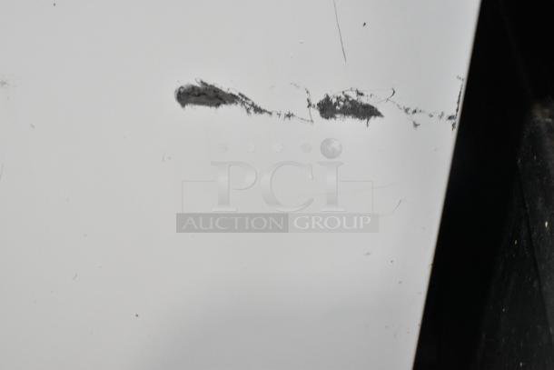 Sears Coldspot 106 metal single door reach-in freezer, 115 volts, 1 phase, shows visible scratches and scuffs on the surface.