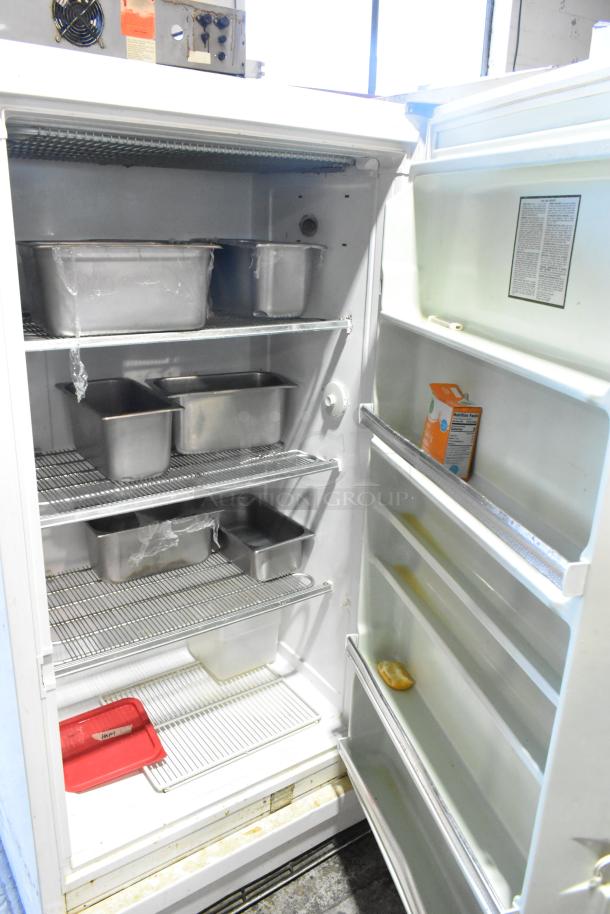 Sears Coldspot 106 metal single door reach-in freezer, 115 volts, 1 phase, with multiple shelves and interior compartments.