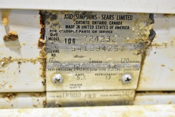 Sears Coldspot 106 metal reach-in freezer label, showing model 106, voltage 120, 1 phase, and other technical specs. Signs of wear.