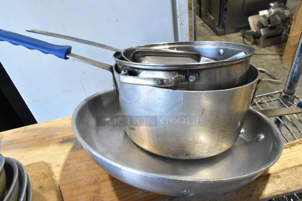 3-tier lot with stainless steel skillets, drop-in bins, and round baking pans. Lightly worn condition. Includes wooden pizza peels (not shown).
