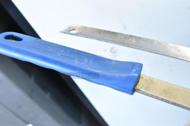 Blue-handled utensil with "Winco" label, part of 3-tier auction lot with pizza peels, bins, skillets, and pans.