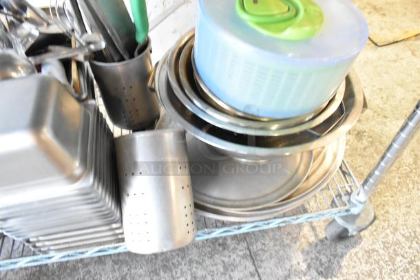 3-tier lot with wooden pizza peels, stainless steel drop-in bins, skillets, round baking pans, assorted kitchen items.