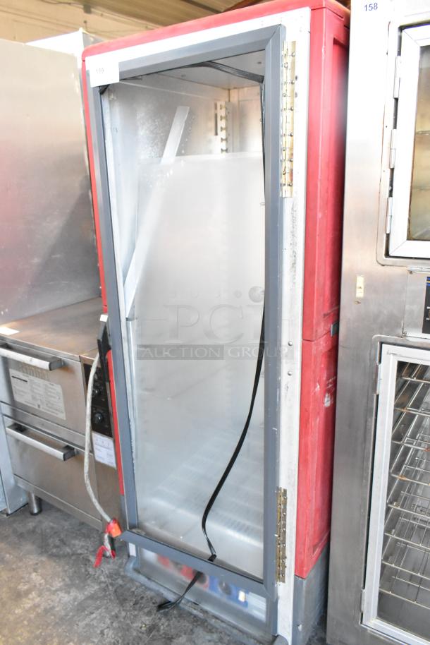 Metro C5 Metal Commercial Heated Holding Cabinet with casters, red and silver, used condition, open door showing interior shelves.