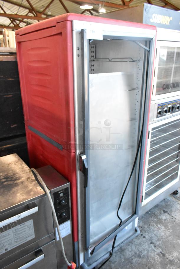 Metro C5 Heated Holding Cabinet, red metal, on commercial casters, open door, good condition, control panel visible.