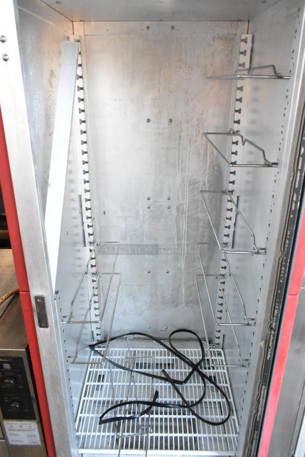 Metro C5 metal commercial heated holding cabinet, interior view, on commercial casters. Visible racks and power cord, in used condition.