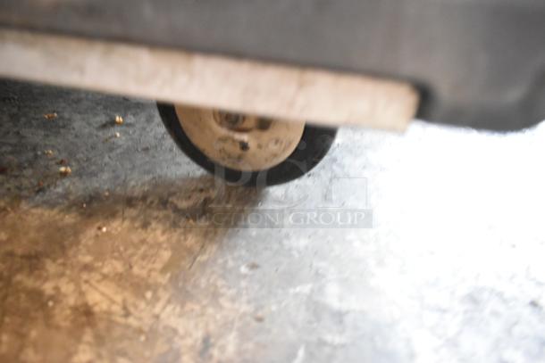 Close-up of a wheel on the Metro C5 heated holding cabinet, showing its sturdy commercial caster for mobility.
