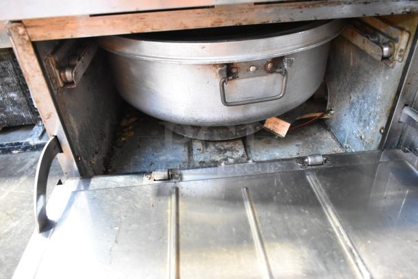 Rinnai stainless steel commercial gas-powered 2-drawer food warmer with visible wear and discoloration, interior shown.