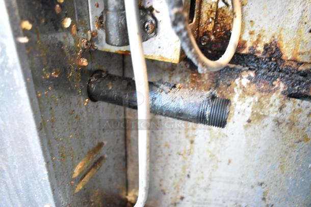 Rinnai stainless steel commercial gas-powered food warmer, showing interior condition with visible grime and wear.