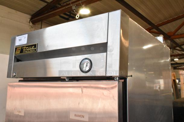 True T-23F stainless steel commercial freezer, single door, with poly coated racks, thermometer gauge, and visible labels.