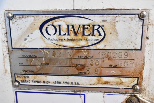 Oliver 702-N Metal Commercial Bagel Slicer label, showing model, serial number 180289, voltage, and manufacturing details.