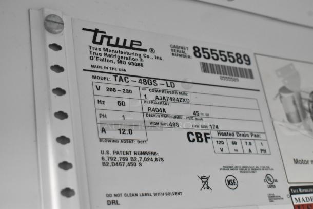 Label on True TAC-48GS-LD Merchandiser showing model, make, voltage (208-230V), and refrigerant details.