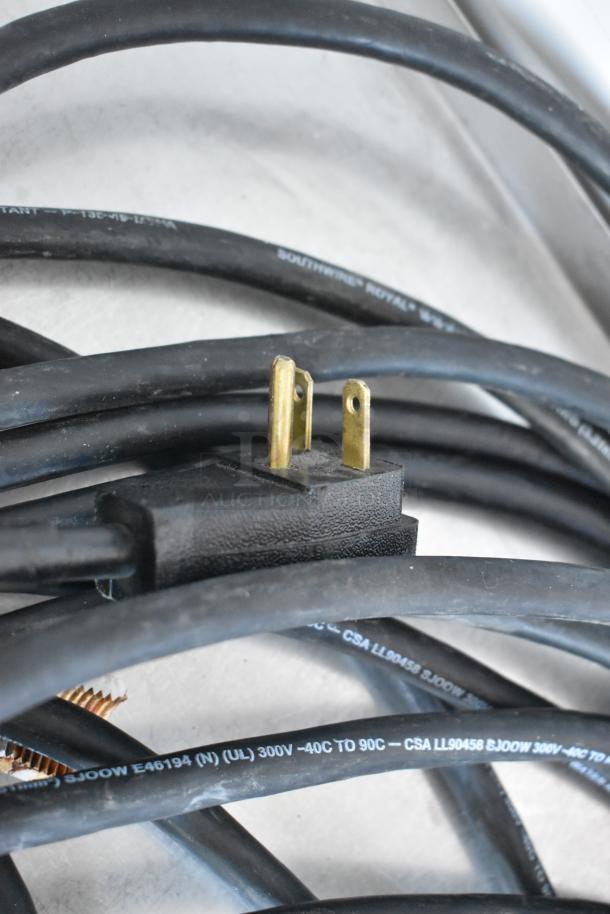 Close-up of a power cable and plug for True TAC-48GS-LD merchandiser, showing voltage and temperature markings.
