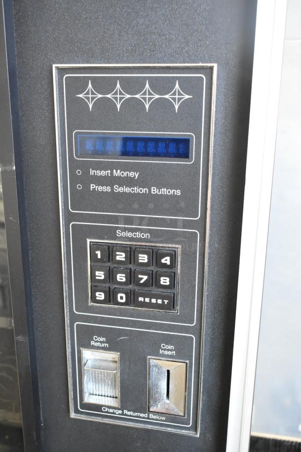 Genesis 5900 JR vending machine control panel with number keypad, coin insert, and return slots.