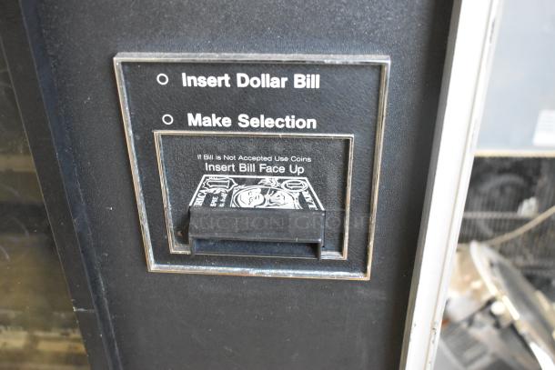 Genesis 5900 JR metal vending machine, floor style, 115 volts, 1 phase. Dollar bill insert and selection panel shown.