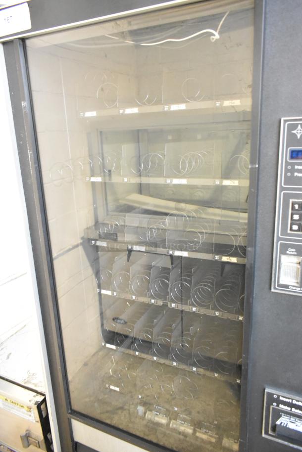 Genesis 5900 JR vending machine, metal, floor style, 115 volts, 1 phase, displays coils, operational buttons visible.