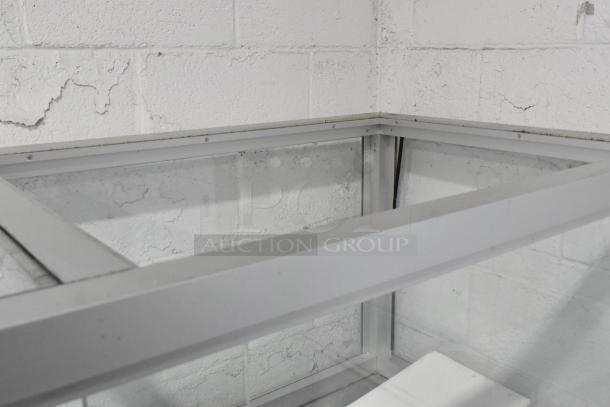 Atosa MSF8008 stainless steel commercial prep table with sneeze guard, seen in a sturdy frame, 115V, 1-phase, on casters.