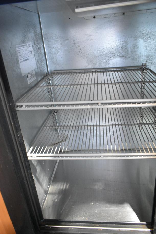 Beverage Air BB72HC-1-GS-B-27 commercial cooler interior. Visible shelves, metal finish, and condition. Model label attached.