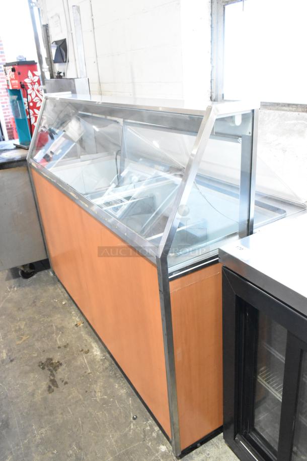 Metal commercial ice cream dipping cabinet with ice cream tub collars, 115 volts, 1 phase, in used condition.