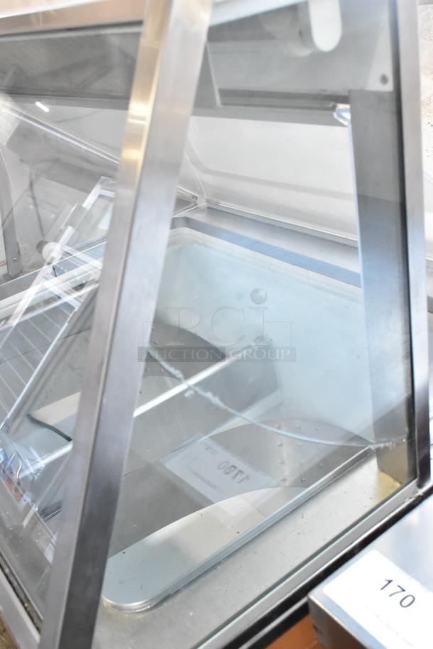 Metal commercial ice cream dipping cabinet with glass panels, features ice cream tub collars. Runs on 115 volts, 1 phase.