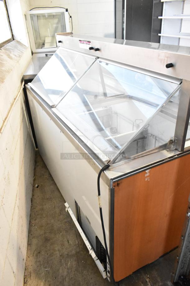 Metal commercial ice cream dipping cabinet with tub collars, 115 volts, 1 phase. Features sliding glass lids, good condition.