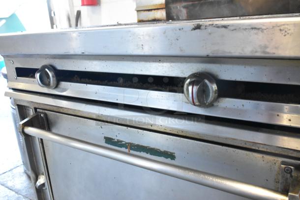 Jade Range JTRH-2FHT-36 stainless steel 2 burner range with oven and back splash, on casters. Shows signs of use.