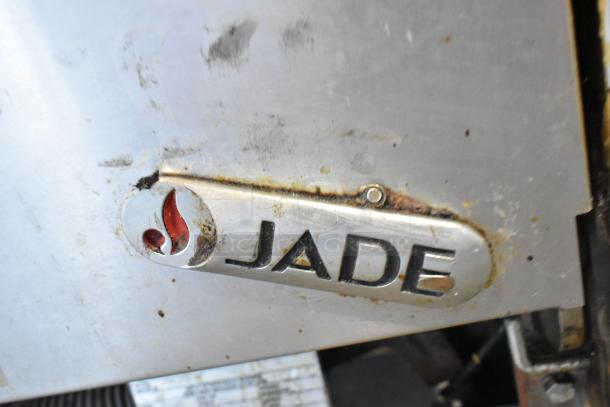 Jade Range logo on stainless steel commercial gas range JTRH-2FHT-36; shows signs of use and wear.