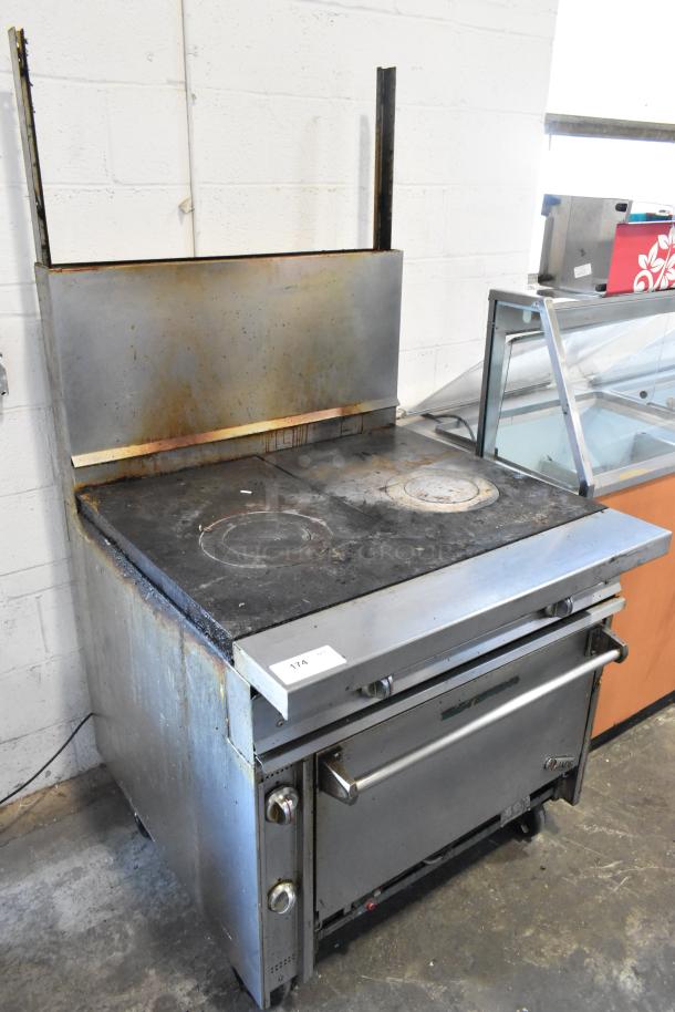 Jade Range JTRH-2FHT-36 stainless steel 2 burner range with oven, back splash, and casters. Used condition, natural gas.