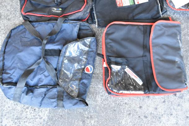 Seven assorted hot food carrying bags, each with black fabric and red trim. Some have clear pockets and visible logos. Good condition.