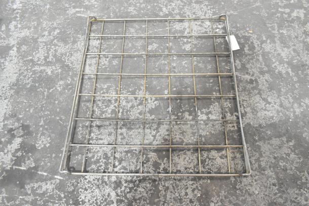 Metal rack with grid structure, sturdy, slightly worn condition, ideal for shelving or storage use.