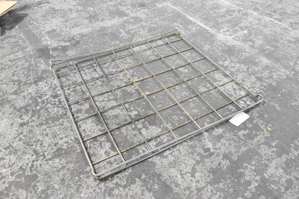 Sturdy metal rack with grid design, showing minor wear, ideal for storage or industrial use. No visible labels.