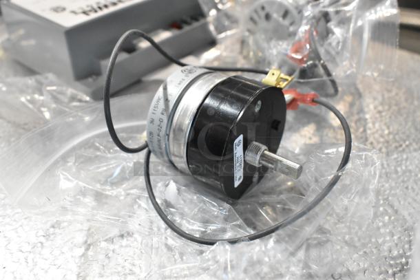 4 brand new scratch and dent items including Fenwal Controls ignition system, Delfield assembly. Clear plastic wrapping visible.