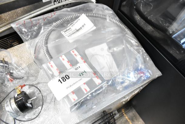4 new scratch and dent items, including Fenwal Controls Ignition System and Delfield 000-282-00HE-S Assy. Packaged in labeled bags.