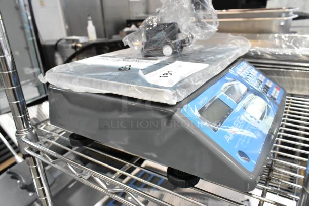 AvaWeigh 334PCS60 60 lb. digital price computing scale, brand new with minor scratches, blue and gray control panel.