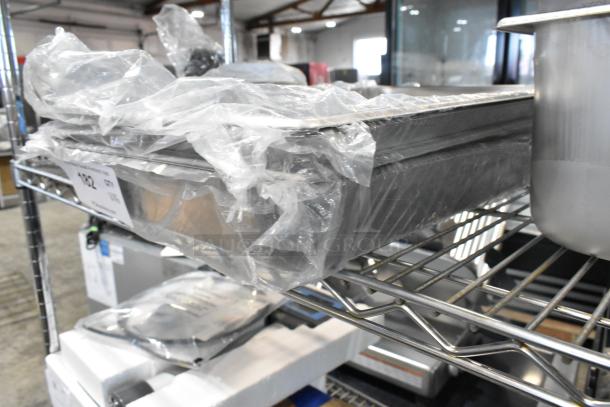Six brand new scratch and dent stainless steel steam table pans, 24 and 22 gauge, anti-jam, packaged together.