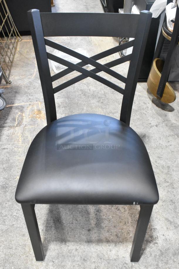Lancaster Table & Seating black metal cross back dining chair, brand new scratch and dent, with black seat cushion.