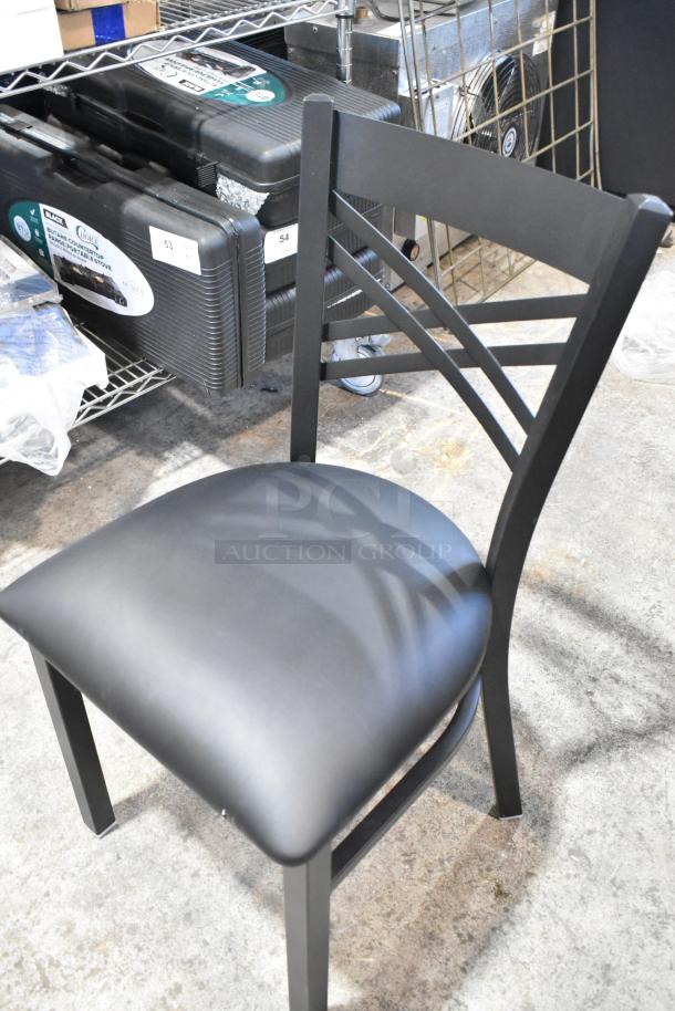 Brand new Lancaster Table & Seating black metal cross back dining chair with black seat cushion.
