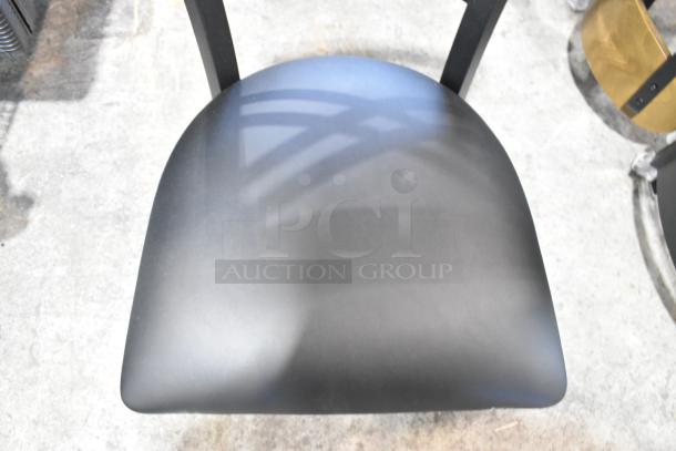 Lancaster Table & Seating black metal cross back dining chair, black seat cushion, new scratch and dent, auction item.