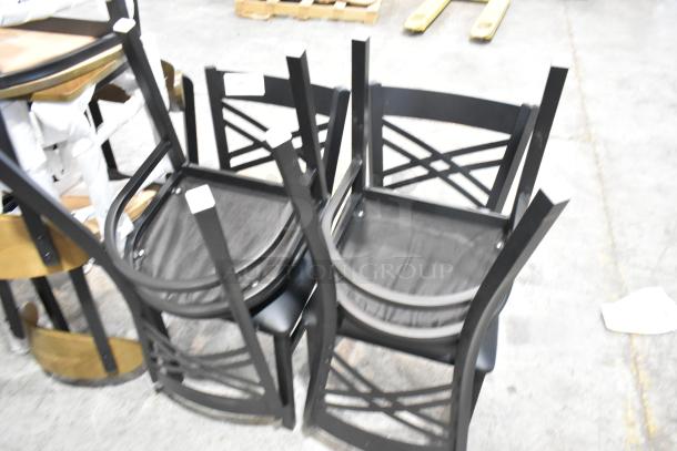 Four new Lancaster Table & Seating black metal dining chairs with cross-back design and black seat cushions, labeled scratch and dent.