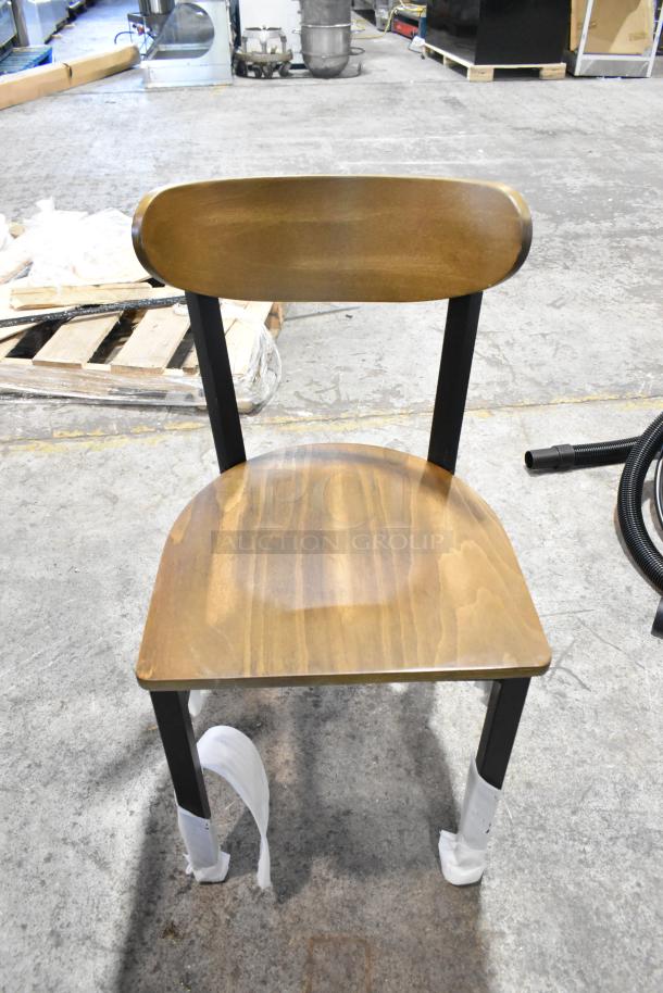 8 new Lancaster Table & Seating dining chairs, black metal frame, wooden backrest and seat. Scratch and dent condition.